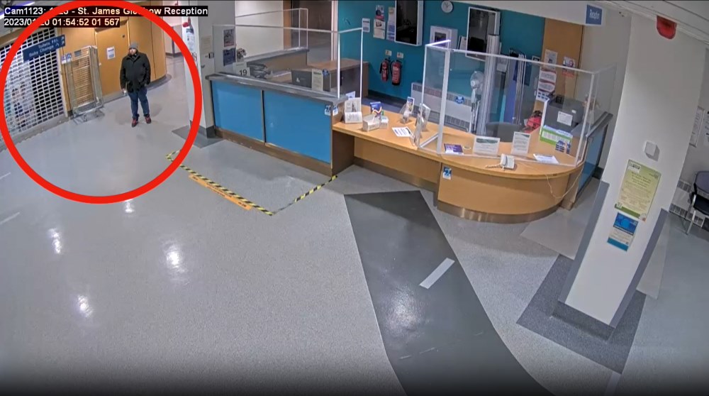 CCTV camera image of the reception at the hospital. Farooq can be seen at the far left of the image