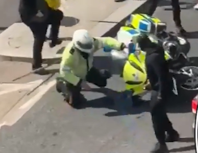 Police officer knocked off motorbike by rioters