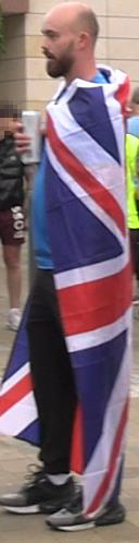 Image of Kieran Usher cloaked in a Union Jack flag