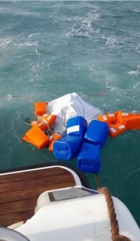 floats and a waterproof bag tethered to the boat