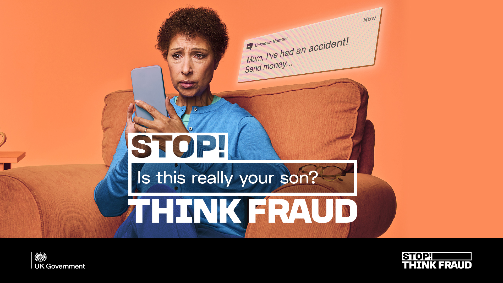 An older woman, sitting in an armchair, is worriedly looking at her phone screen. She is reading a message that says 'Mum! I've had an accident! Send money...'. The message is from an unknown number. The overlay on the image says 'STOP! Is this really your son? THINK FRAUD.''